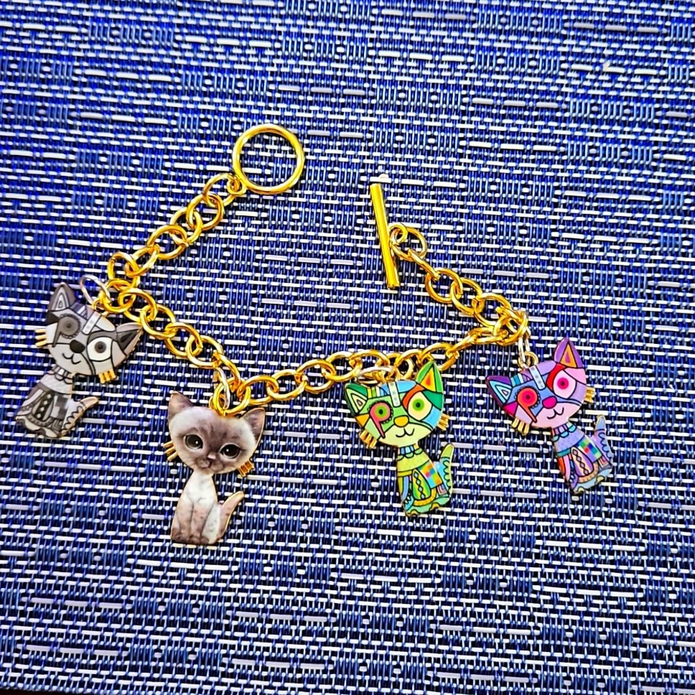 Gold charm bracelet with cats